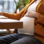 Woman writing down questions to ask gynecologist when pregnant