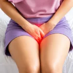 UTI FAQs image showing a woman experiencing urinary tract infection symptoms