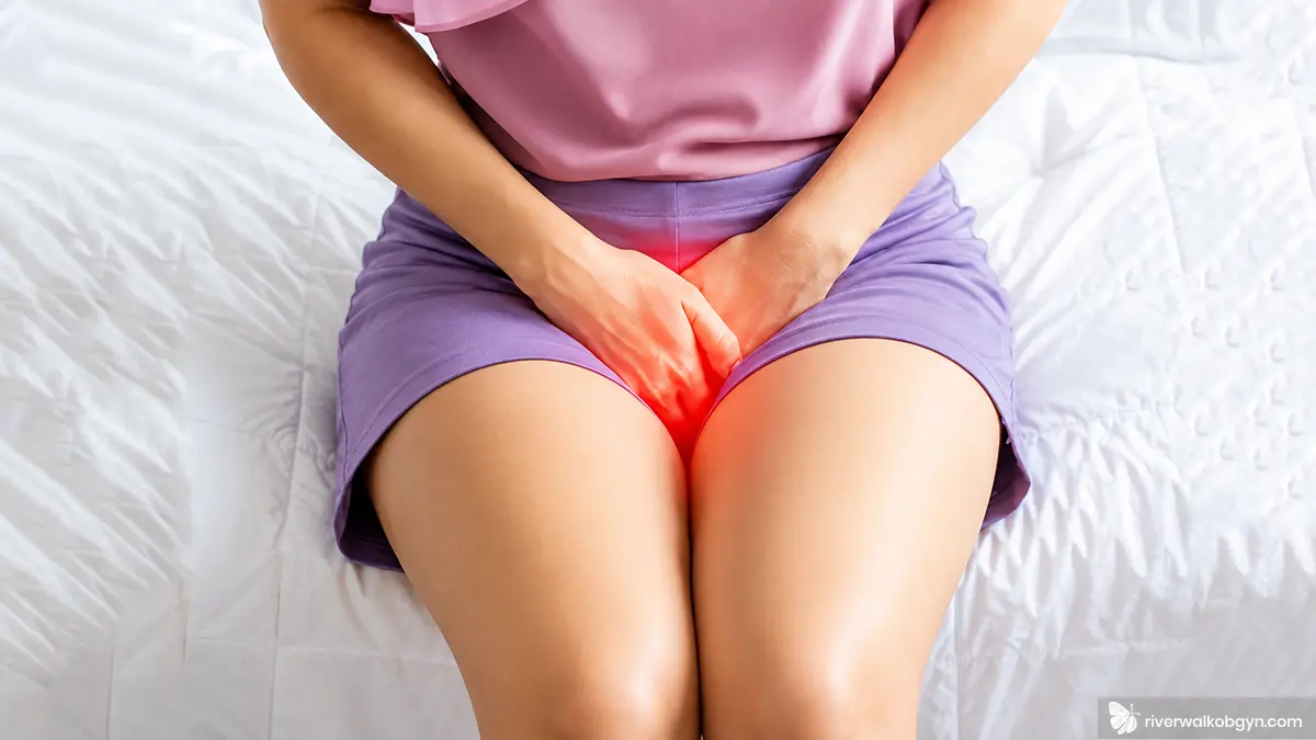 UTI FAQs image showing a woman experiencing urinary tract infection symptoms