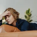 Girl laying on the bed with blood clots during your period