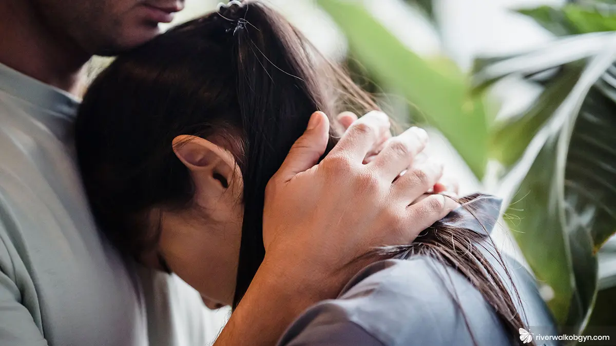 Sad couple hugging each other trying to protect their mental health during fertility treatment