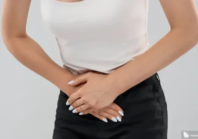 Woman crunched over experiencing pelvic pain in women
