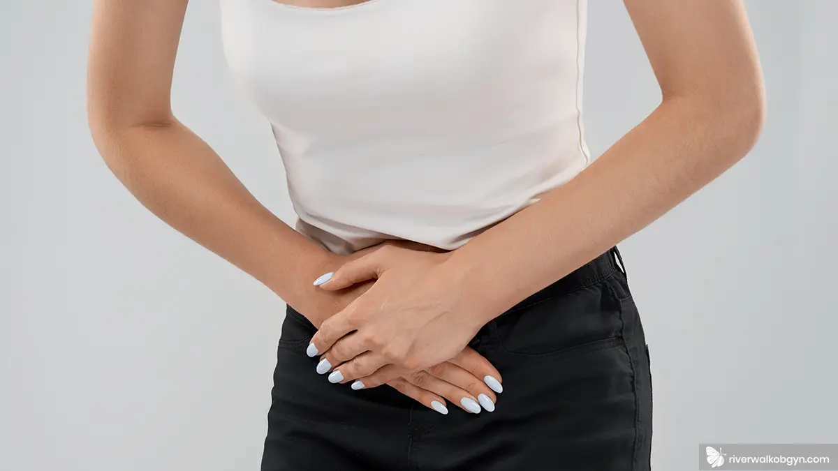 Woman crunched over experiencing pelvic pain in women